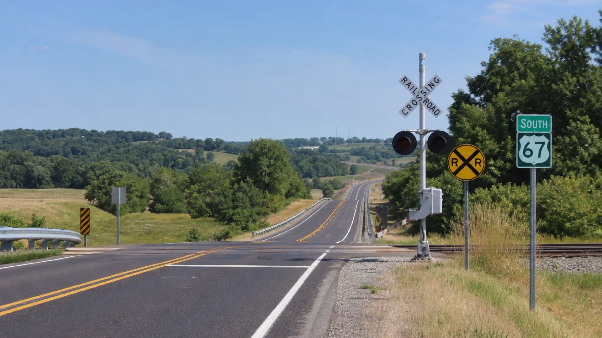 US Highway 67 southbound with a railroad crossing sign in Jefferson County, Missouri.